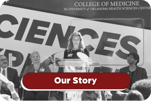Black and white image of Melissa Warde delivering a speech in front of the Health Sciences Explorer at the ribbon cutting ceremony. Title on image says: Our Story